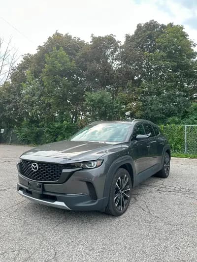 non-smoker 2024 Mazda CX-50 GT 2.5T in Gunmetal with Black interior, front three quarter view