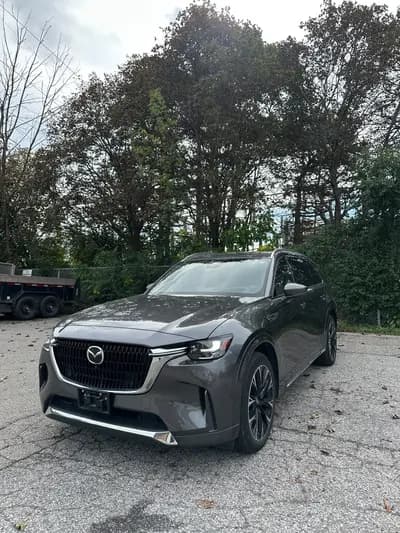 non-smoker 2025 Mazda CX-90 Signature MHEV in Gunmetal with Brown interior, front three quarter view